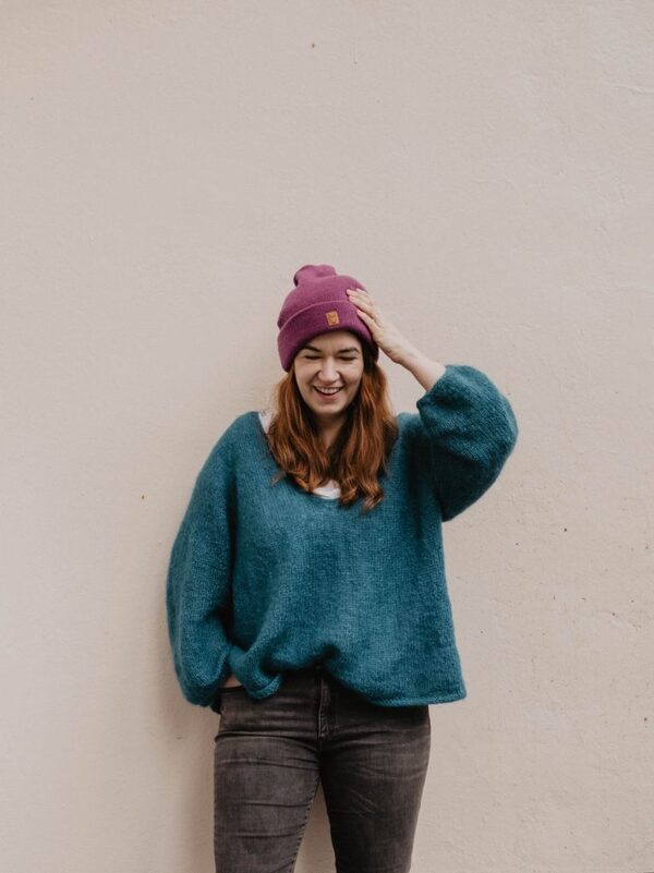 Johanna from Pinkepank, wearing a knitted hat and a green jumper